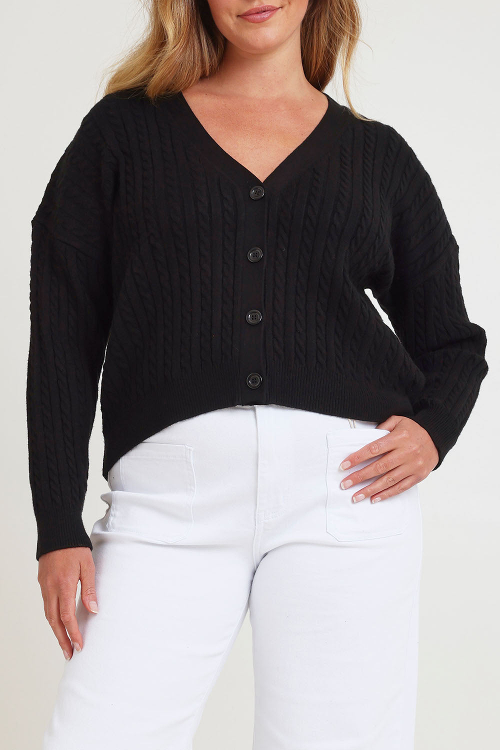 Model Chanel wearing size XL of The Cable Knit Button Up Cardigan in colour Black (Black), from the front, cropped image