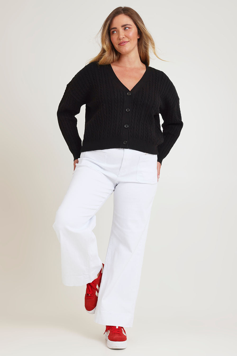 Model Chanel wearing size XL of The Cable Knit Button Up Cardigan in colour Black (Black), from the front, showing the whole outfit