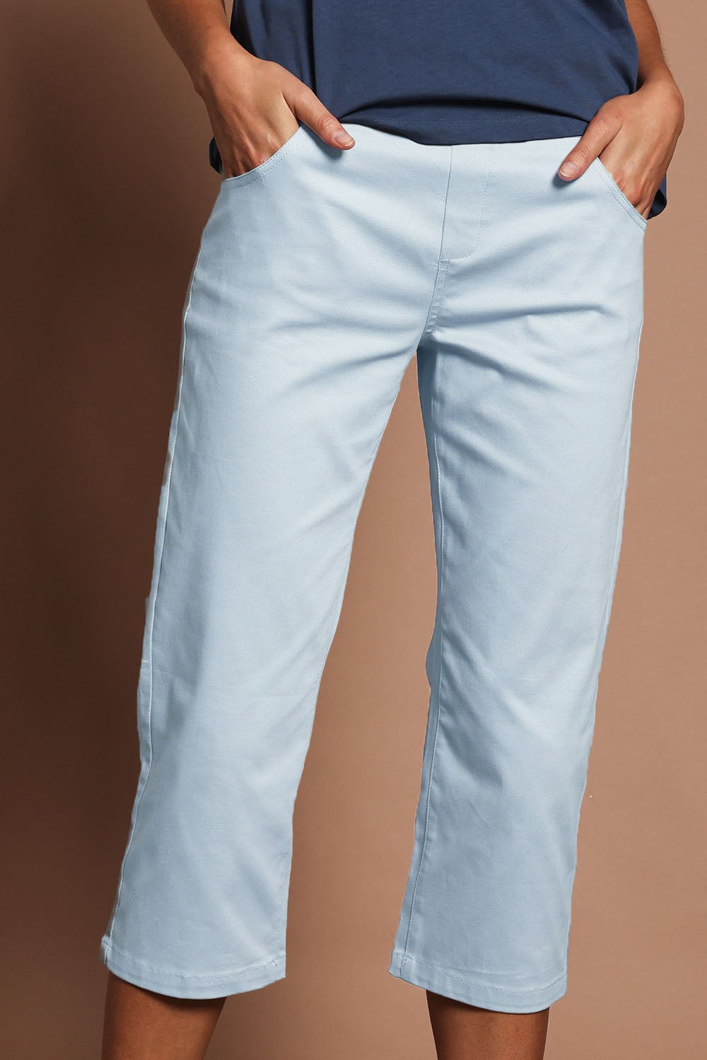 Model Madeline wearing size 10 of The Pull On Cotton Cropped Pant With Pockets in colour Bluegrey (Blue), from the front, cropped image