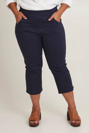 Model Ashleigh wearing size 16 of The Pull On Cotton Cropped Pant With Pockets in colour Navy (Blue), from the front, cropped image