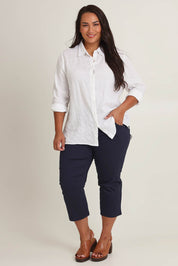 Model Ashleigh wearing size 16 of The Pull On Cotton Cropped Pant With Pockets in colour Navy (Blue), from the front, showing the whole outfit