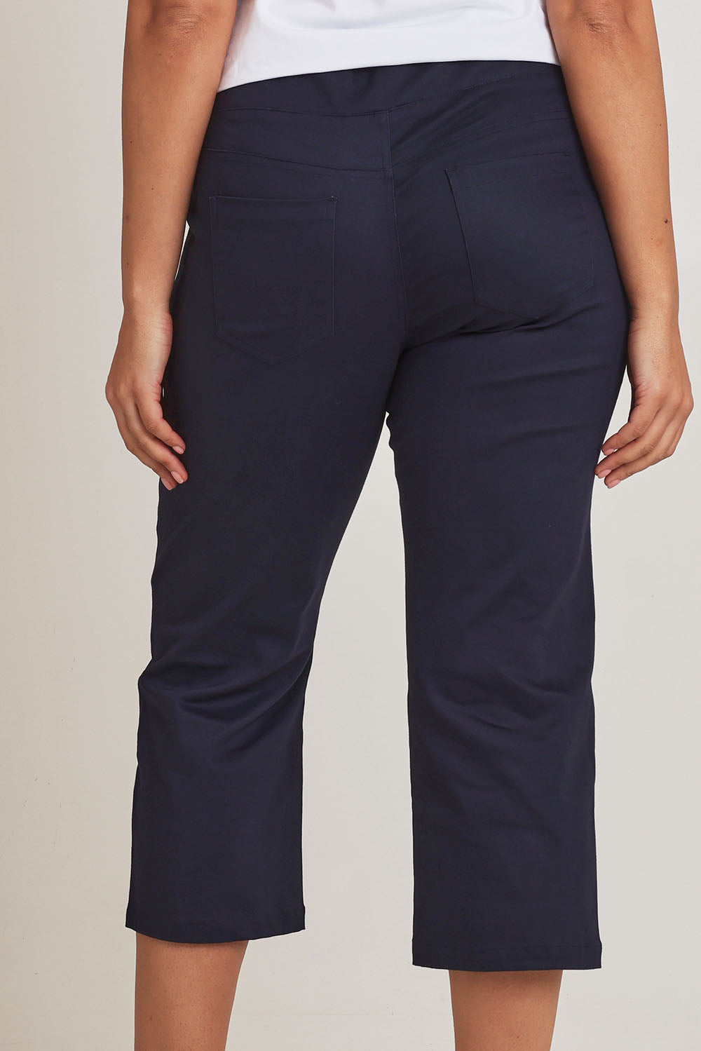 Model Terri-Leigh wearing size 14 of The Pull On Cotton Cropped Pant With Pockets in colour Navy (Blue), from the back