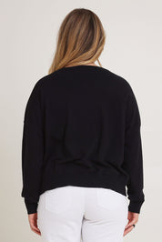 Model Chanel wearing size XL of The Essential Cropped Modal Blend Jumper in colour Black (Black), from the front, cropped image