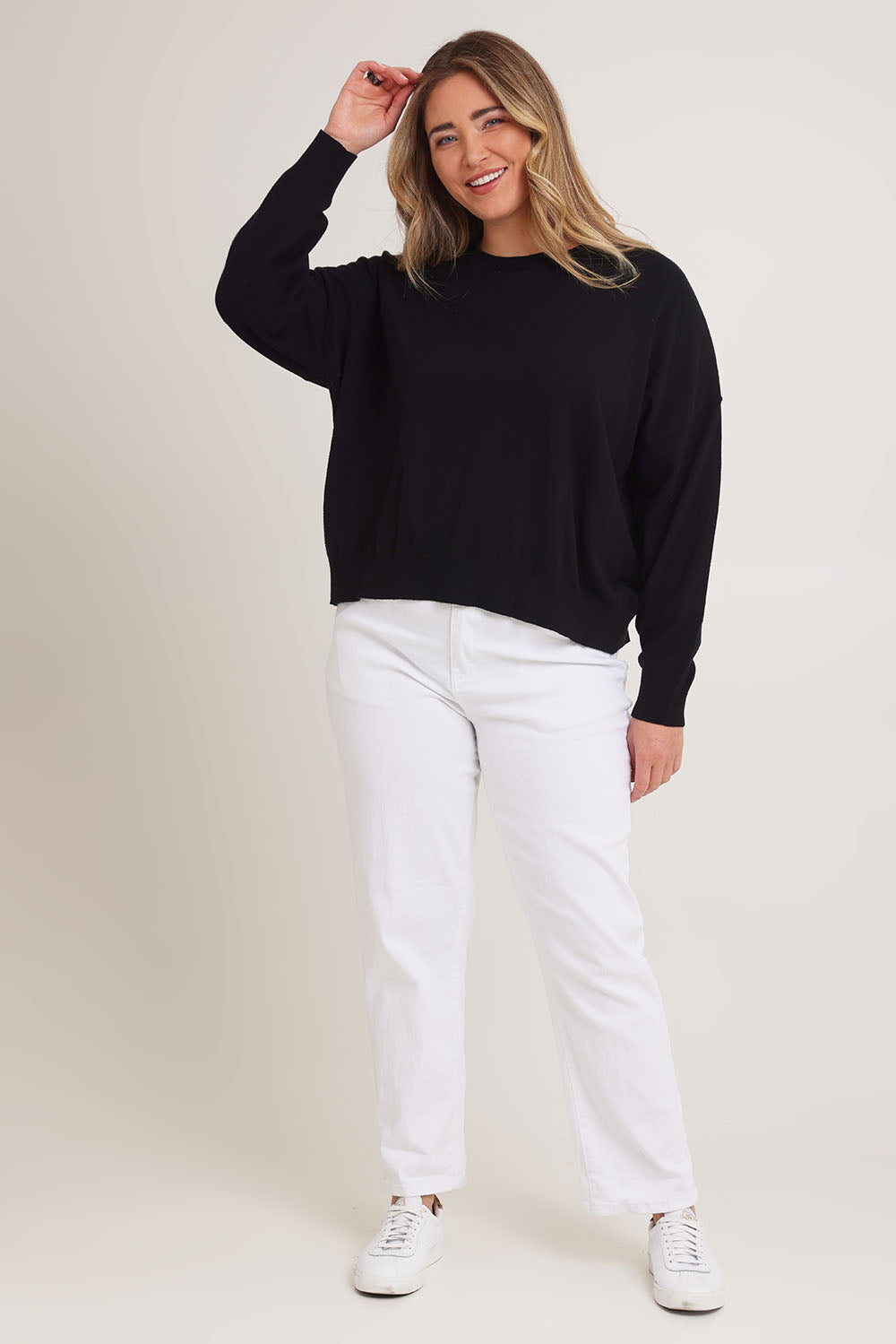 Model Chanel wearing size XL of The Essential Cropped Modal Blend Jumper in colour Black (Black), from the front, showing the whole outfit