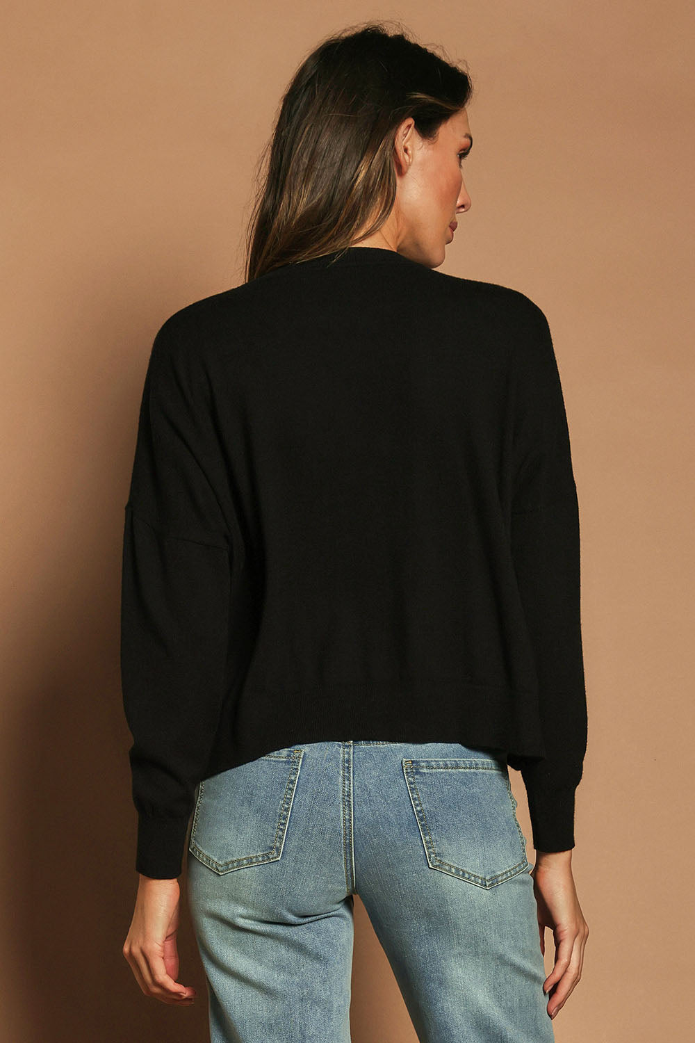 Model Madeline wearing size S of The Essential Cropped Modal Blend Jumper in colour Black (Black), from the back