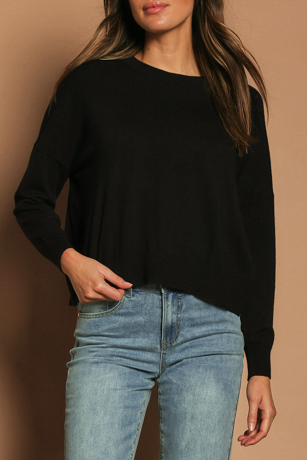 Model Madeline wearing size S of The Essential Cropped Modal Blend Jumper in colour Black (Black), from the front, cropped image