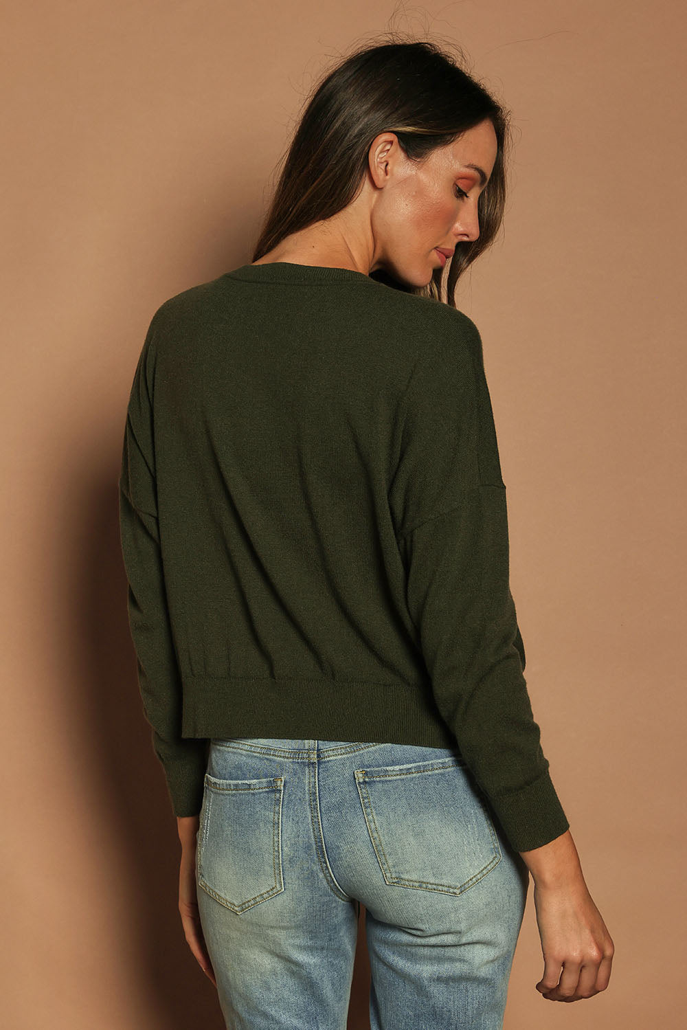 Model Madeline wearing size S of The Essential Cropped Modal Blend Jumper in colour Pine (Green), from the back