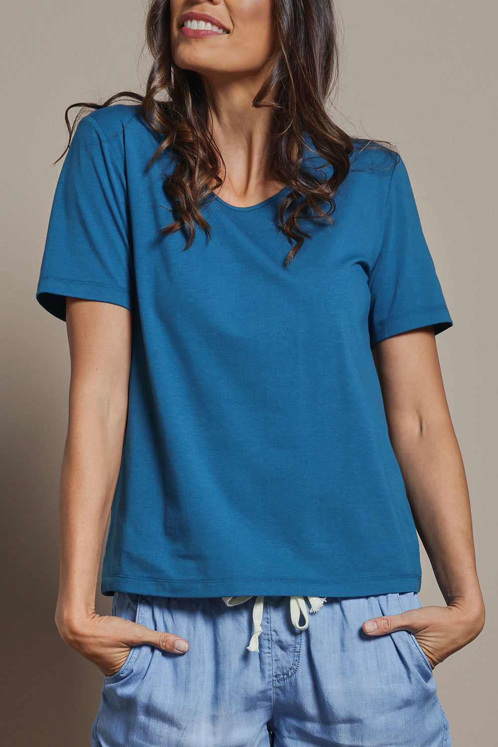 Model Amanda wearing size 10 of The Classic Cotton Blend Short Sleeve Tee in colour Petrol (Blue), from the front, cropped image