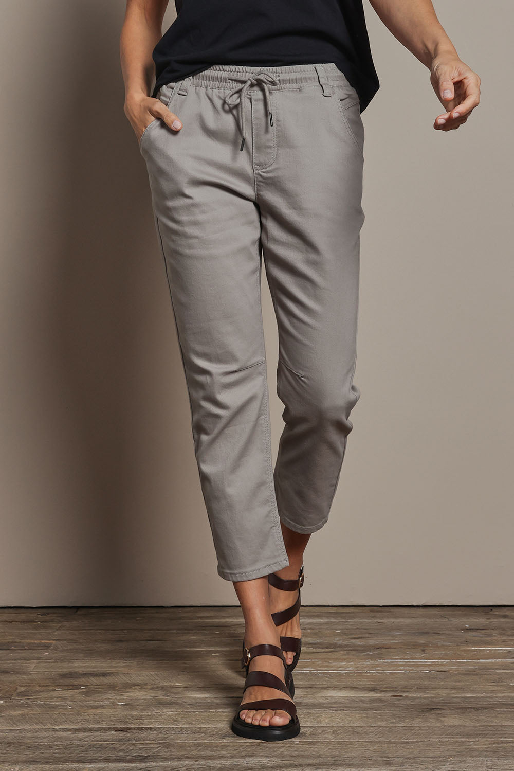 Model Amanda wearing size 10 of The Pull On Cotton Pant With Drawstring in colour Biscuit, from the front, cropped image