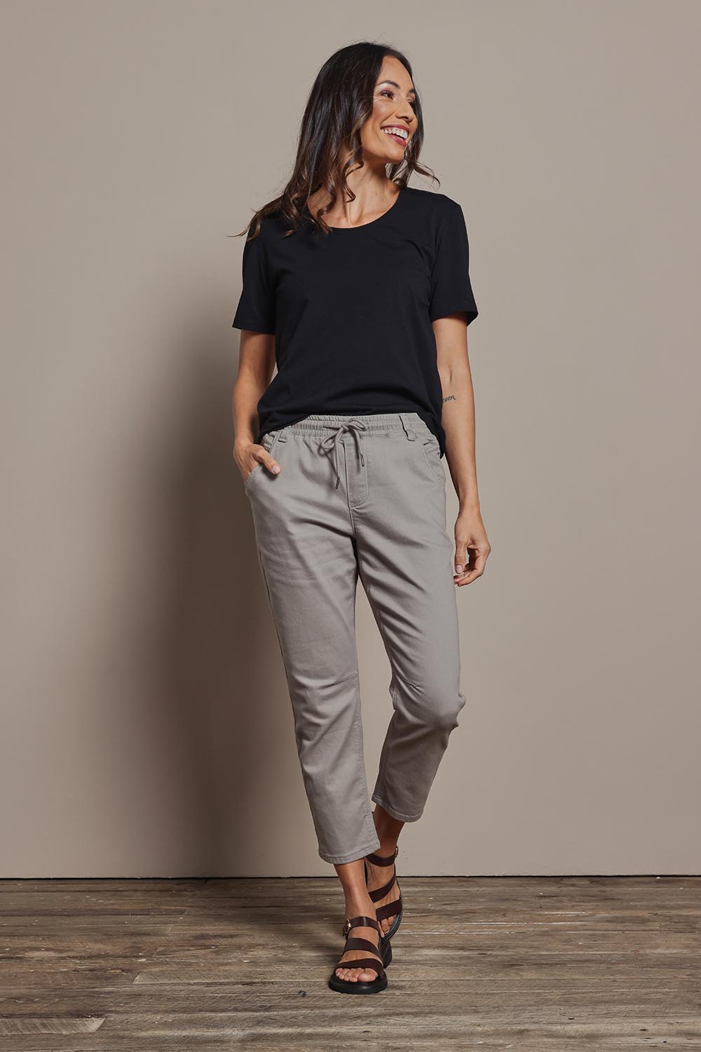 Model Amanda wearing size 10 of The Pull On Cotton Pant With Drawstring in colour Biscuit, from the front, showing the whole outfit