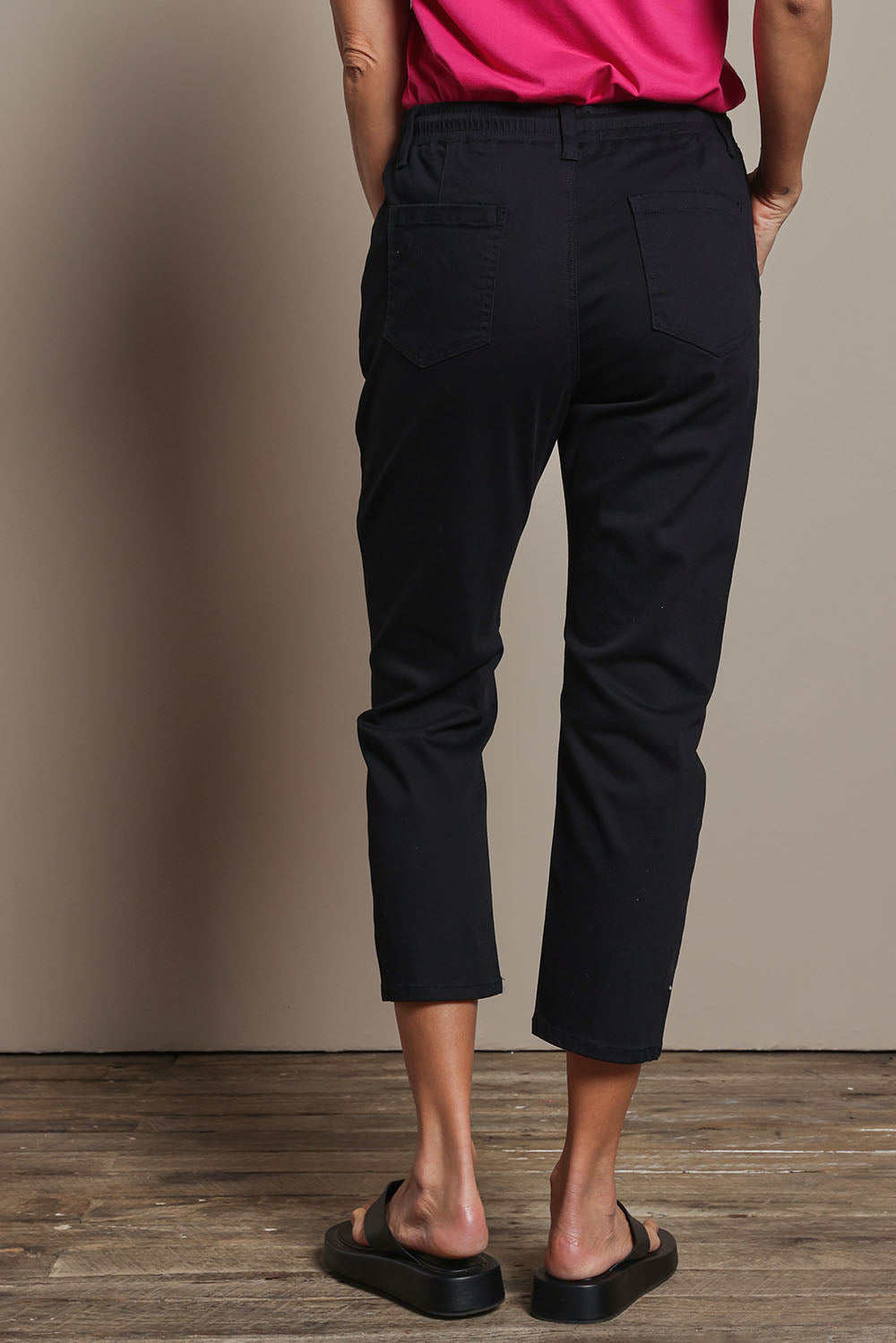 Model Amanda wearing size 10 of The Pull On Cotton Pant With Drawstring in colour Black (Black), from the back