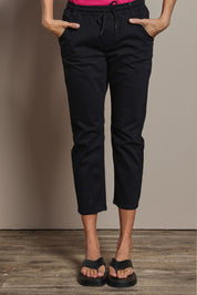 Model Amanda wearing size 10 of The Pull On Cotton Pant With Drawstring in colour Black (Black), from the front, cropped image