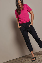 Model Amanda wearing size 10 of The Pull On Cotton Pant With Drawstring in colour Black (Black), from the front, showing the whole outfit