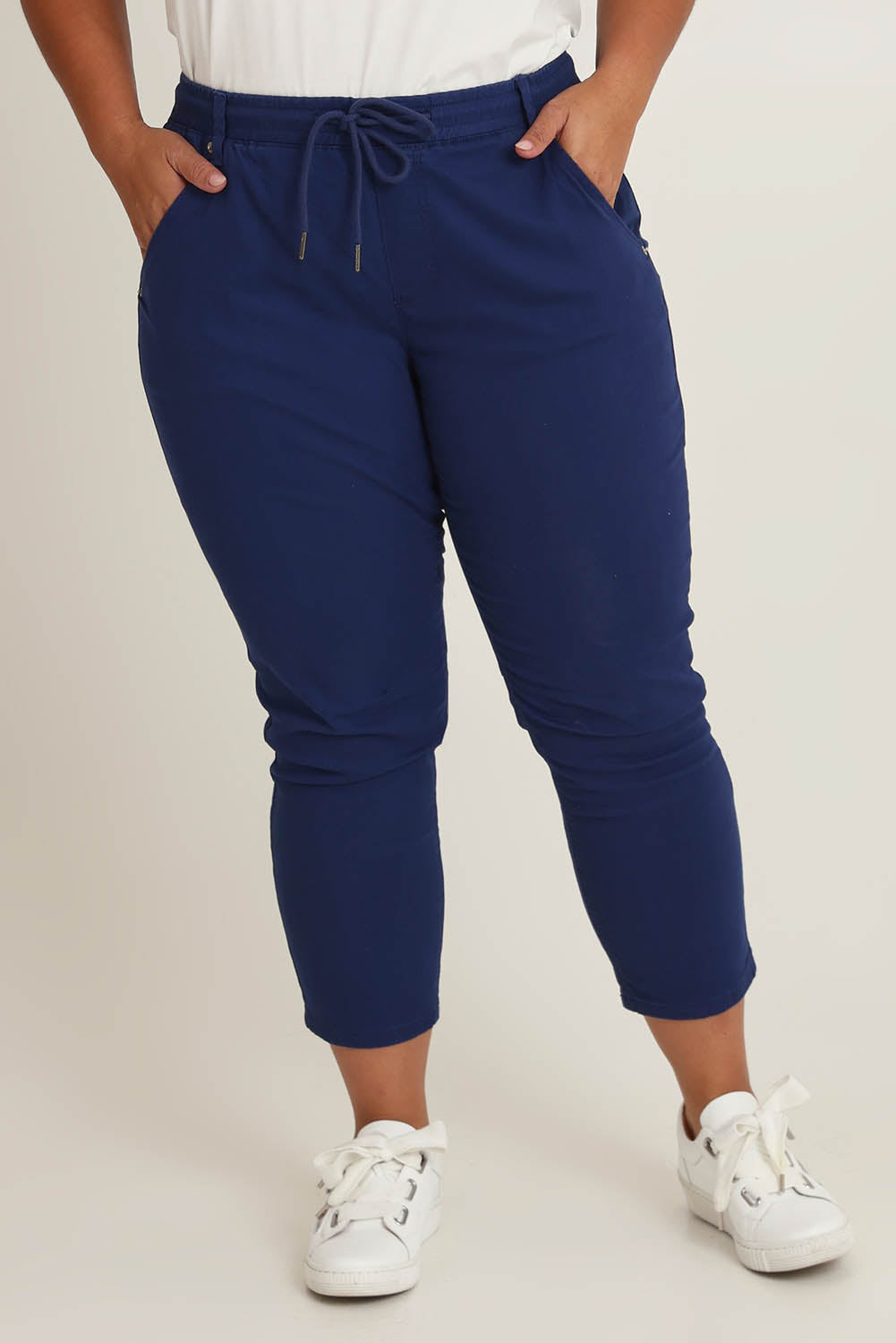 Model Ashleigh wearing size 16 of The Pull On Cotton Pant With Drawstring in colour Indigo (Blue), from the front, cropped image