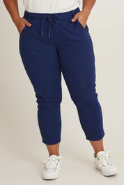 Model Ashleigh wearing size 16 of The Pull On Cotton Pant With Drawstring in colour Indigo (Blue), from the front, cropped image