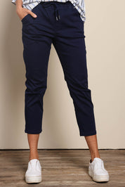 Model Amandam wearing size 10 of the The Pull On Cotton Pant With Drawstring – Navy in colour Navy, in a cropped view