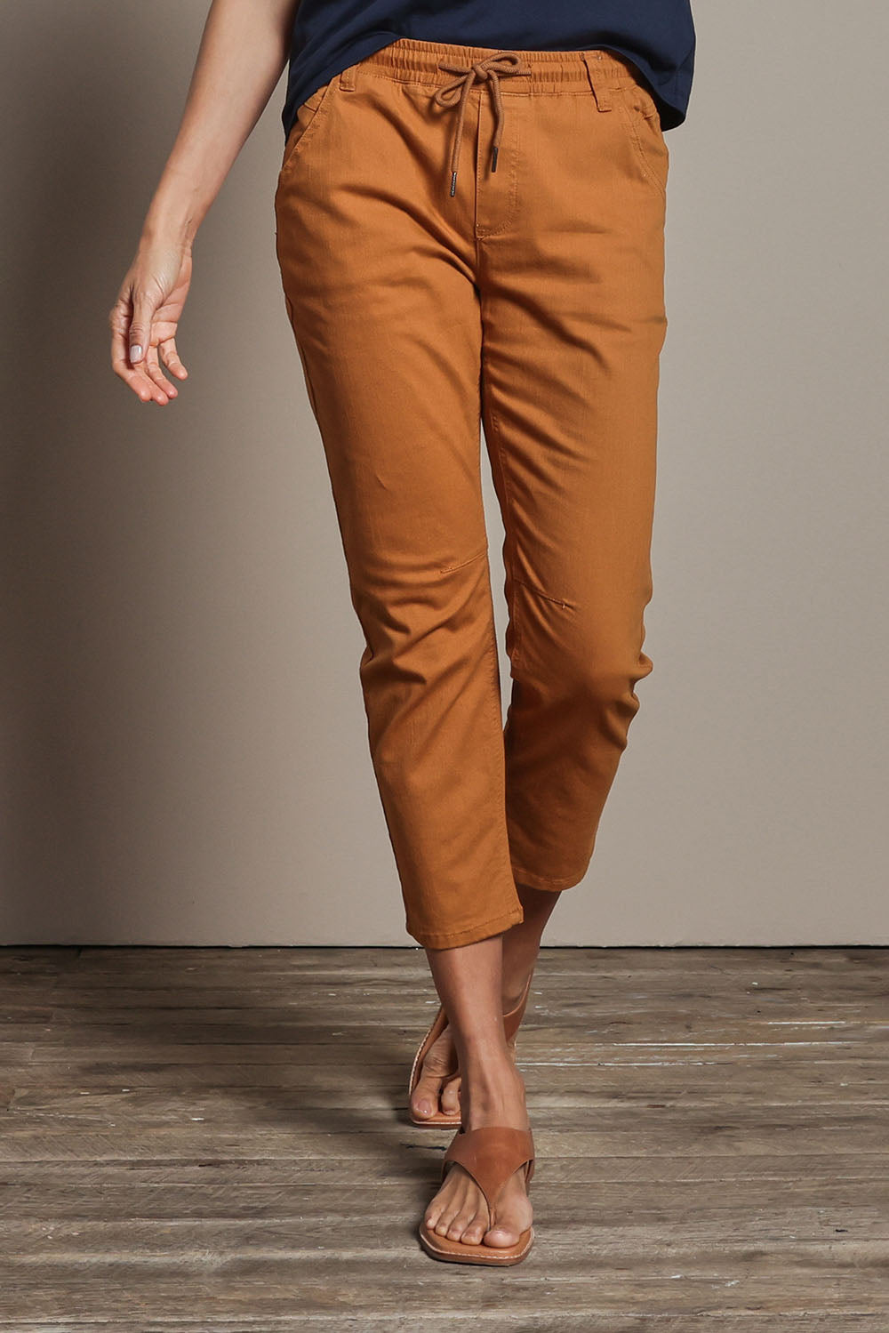 Model Amanda wearing size 10 of The Pull On Cotton Pant With Drawstring in colour Rust, from the front, cropped image