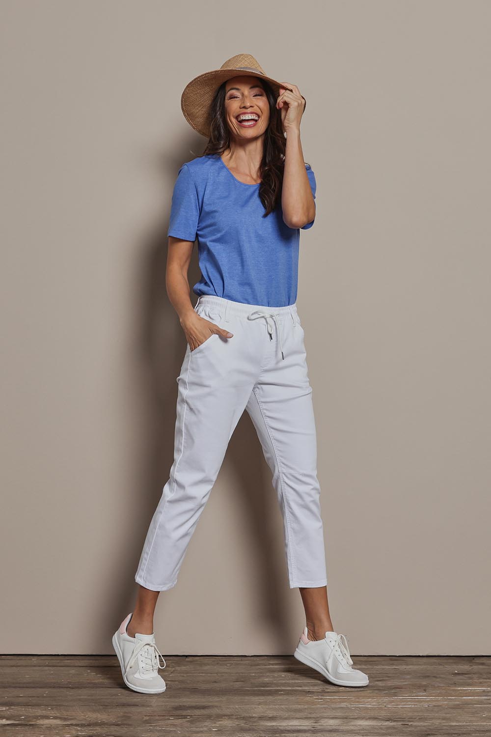 Model Amanda wearing size 10 of The Pull On Cotton Pant With Drawstring in colour White (White), from the front, showing the whole outfit