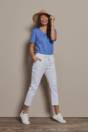 Model Amanda wearing size 10 of The Pull On Cotton Pant With Drawstring in colour White (White), from the front, showing the whole outfit