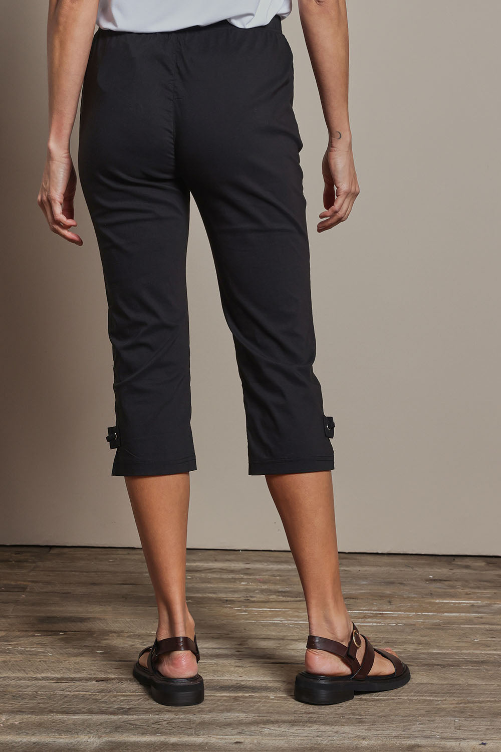 Model Amanda wearing size 10 of The Pull On Elastic Waist Cotton Blend Capri Pant in colour Black (Black), from the back