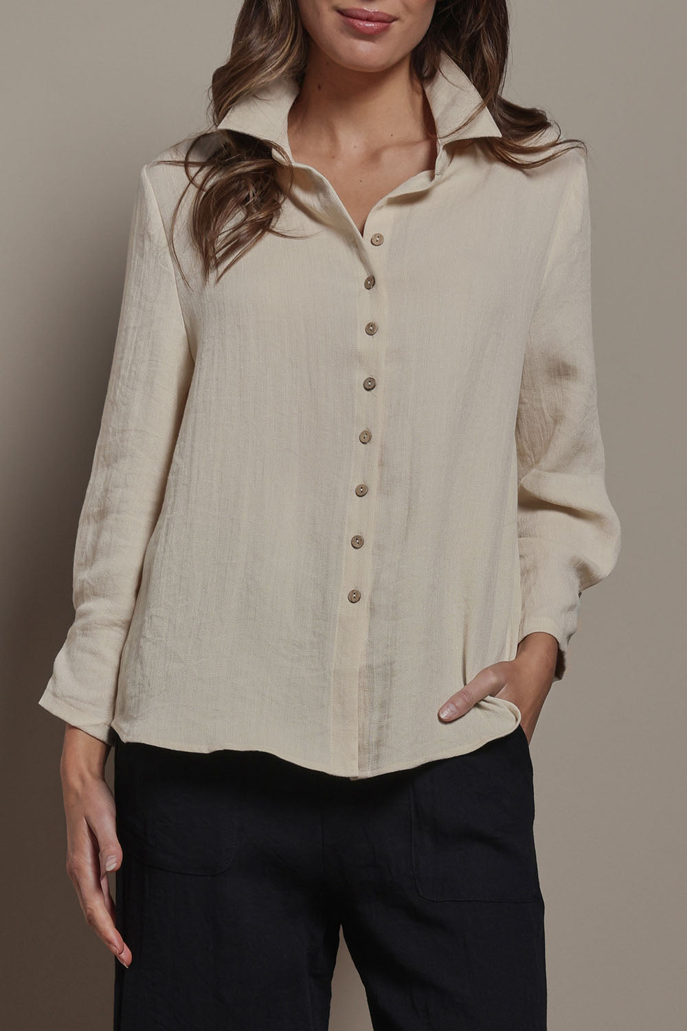 Model Madeline wearing size 10 of The Must Have Linen Look Shirt in colour Sand, from the front, cropped image