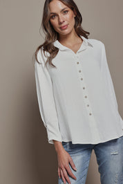 Model Madeline wearing size 10 of The Must Have Linen Look Shirt in colour White (White), from the front, cropped image