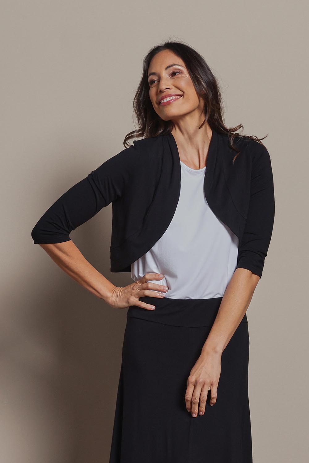 Model Amanda wearing size 10 of The Mix Me Match Me Bamboo Shrug in colour Black (Black), from the front, cropped image