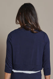 Model Amanda wearing size 10 of The Mix Me Match Me Bamboo Shrug in colour Darknavy (Blue), from the back