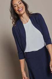 Model Amanda wearing size 10 of The Mix Me Match Me Bamboo Shrug in colour Darknavy (Blue), from the front, cropped image