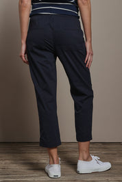 Model Madeline wearing size 10 of The Elastic Waist Pull On Patch Pocket Pant in colour Navy (Blue), from the back