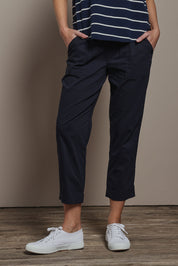 Model Madeline wearing size 10 of The Elastic Waist Pull On Patch Pocket Pant in colour Navy (Blue), from the front, cropped image