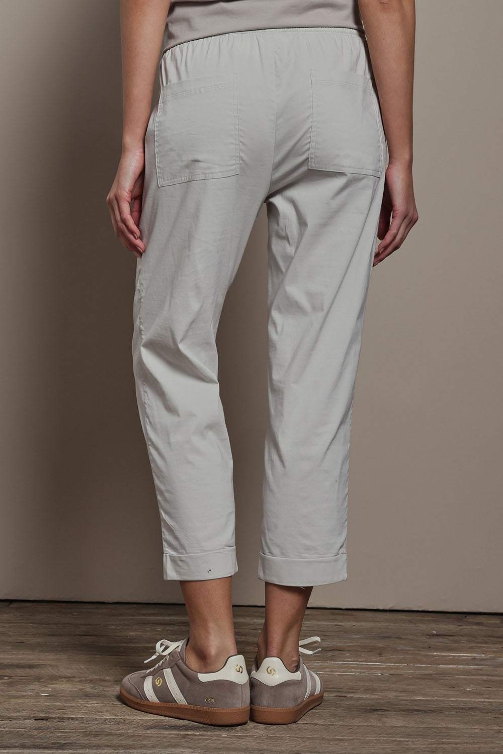 Model Madeline wearing size 10 of The Elastic Waist Pull On Patch Pocket Pant in colour Pummice, from the back