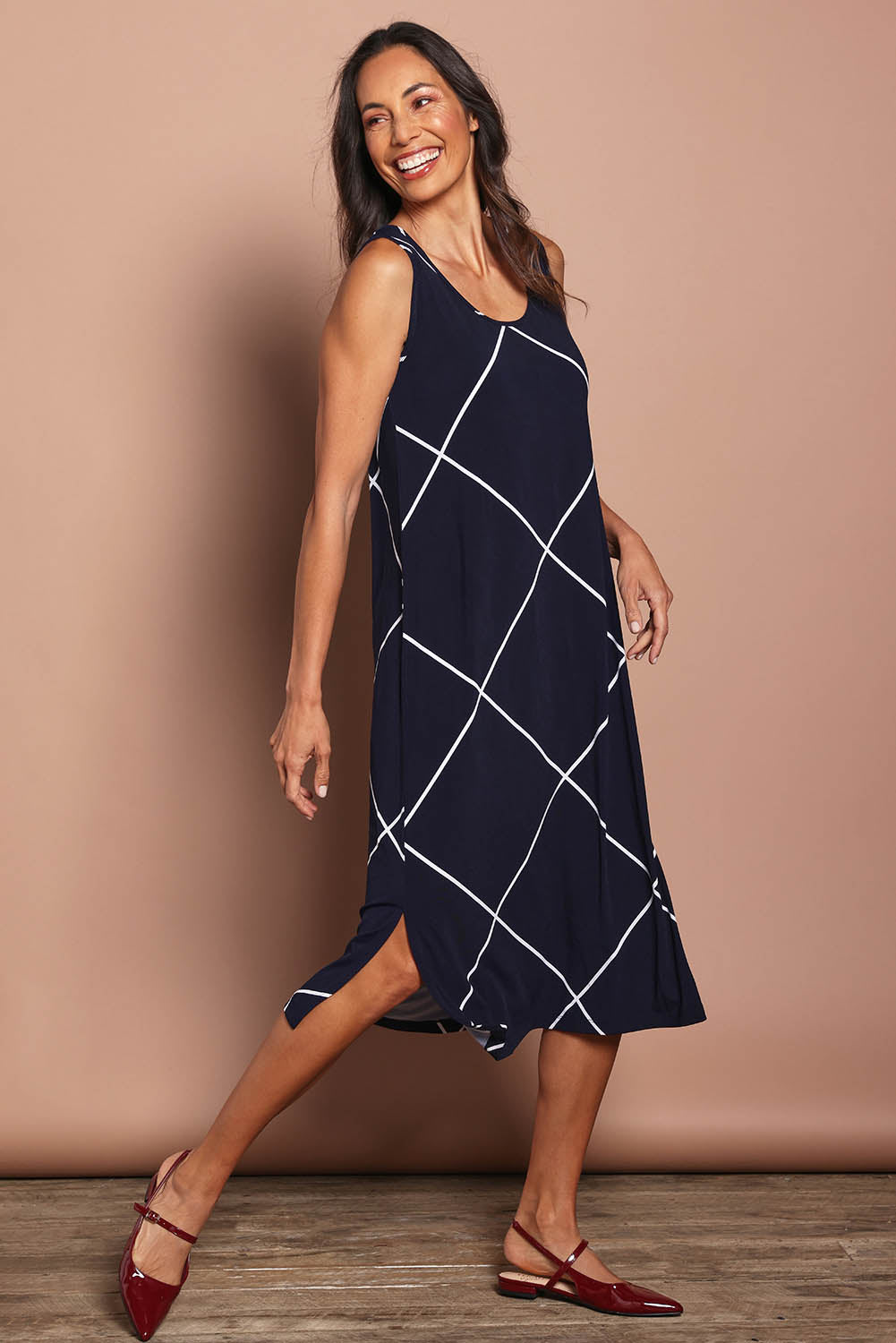 Model Amanda wearing size 10 of The Easy Wear Printed Tank Dress in colour Navywhite (Blue), from the front, showing the whole outfit