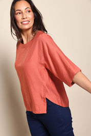 Model Amandam wearing size 10 of the The Popover Cotton Blend Boat Neck Top – Rust in colour Rust, from an angle