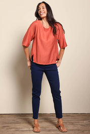 Model Amandam wearing size 10 of the The Popover Cotton Blend Boat Neck Top – Rust in colour Rust, from the front