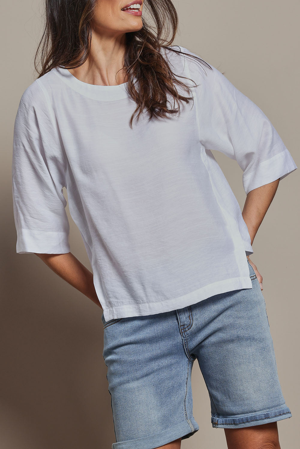 Model Amanda wearing size 10 of The Popover Cotton Blend Boat Neck Top in colour White (White), from the front, cropped image
