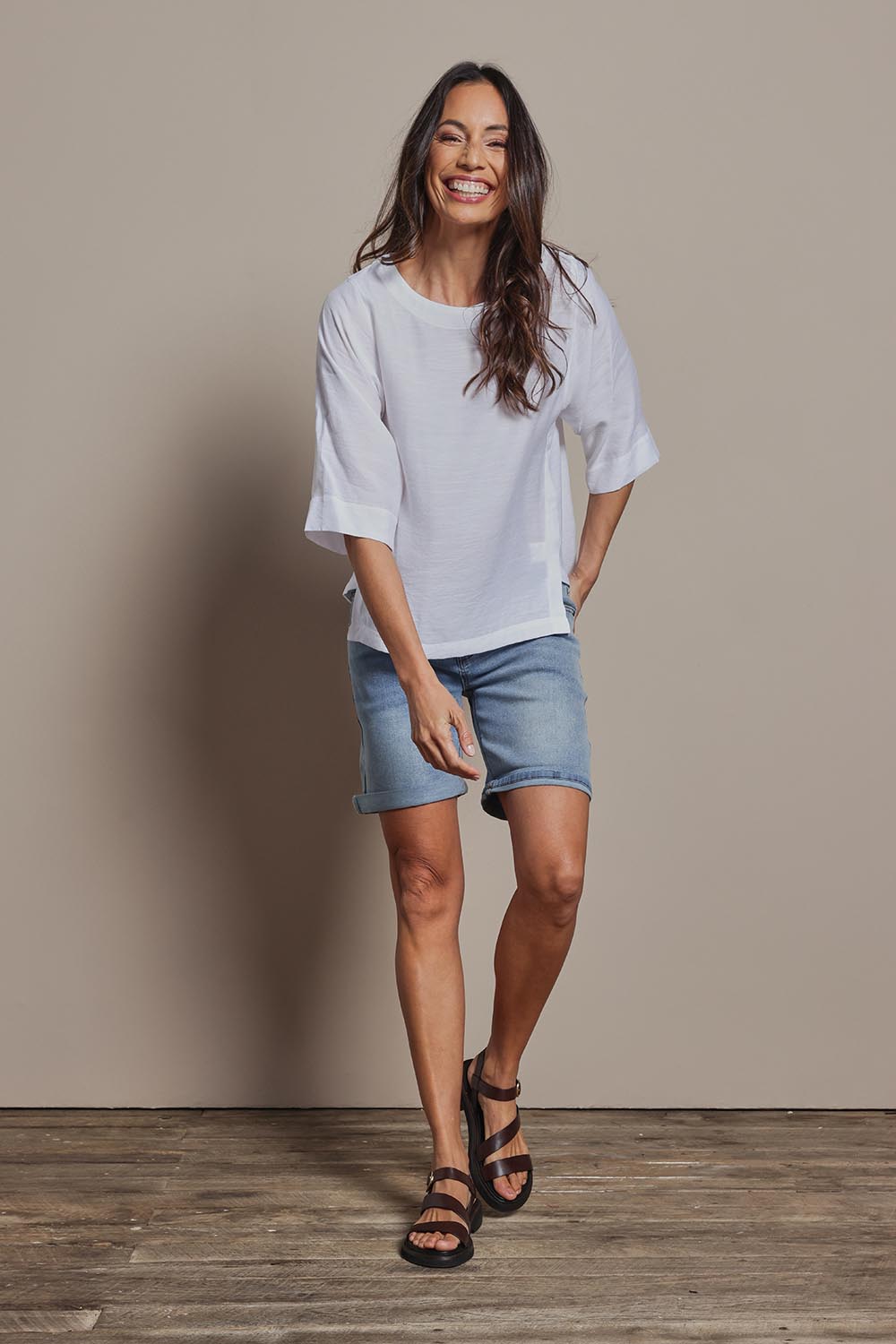 Model Amanda wearing size 10 of The Popover Cotton Blend Boat Neck Top in colour White (White), from the front, showing the whole outfit