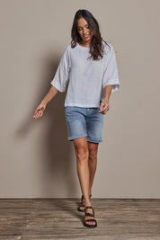 Model Amanda wearing size 10 of The Popover Cotton Blend Boat Neck Top in colour White (White), from the front, showing the whole outfit