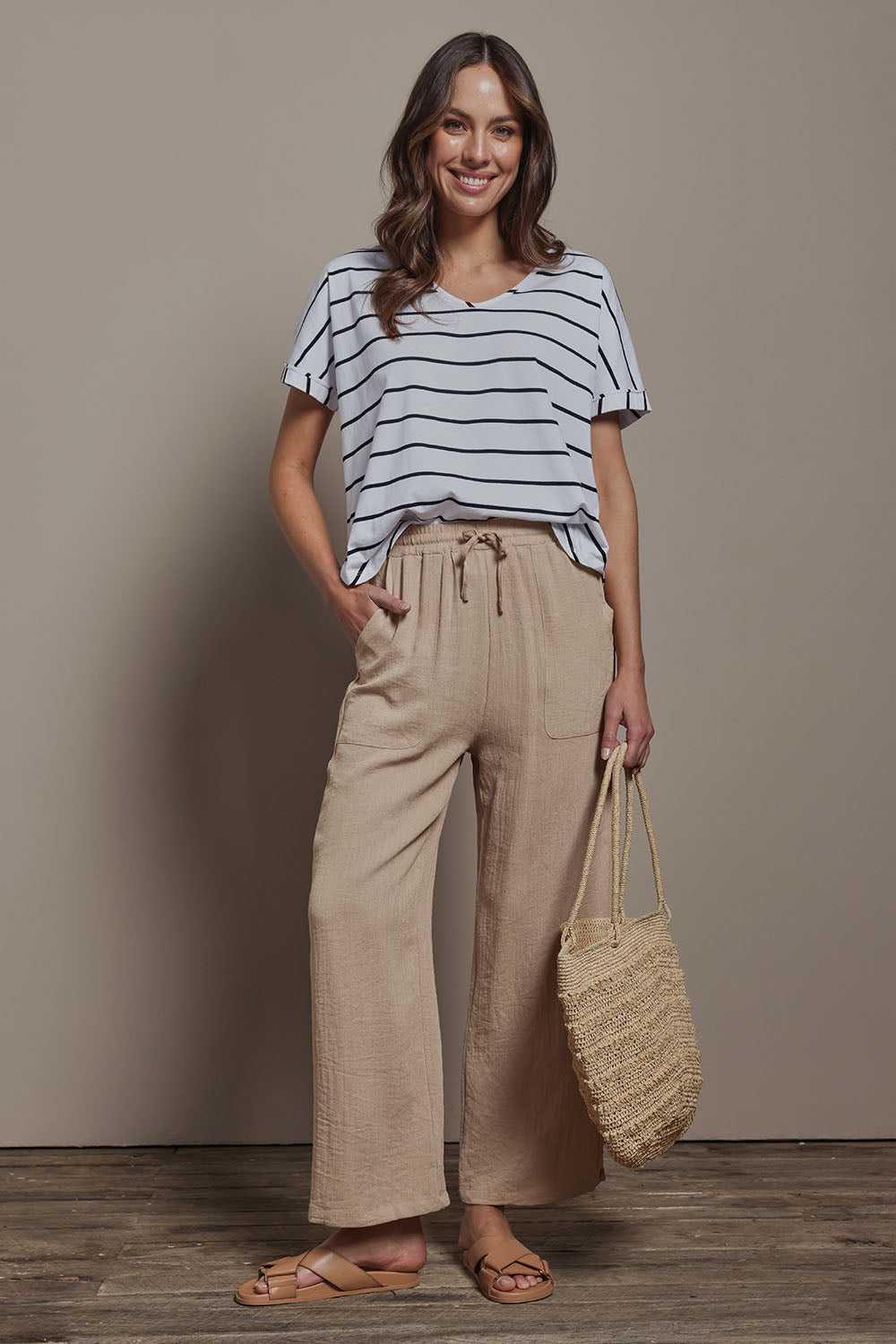 Model Madeline wearing size 10 of The Must Have Linen Look Pull on Pant in colour Biscotti, from the front, showing the whole outfit