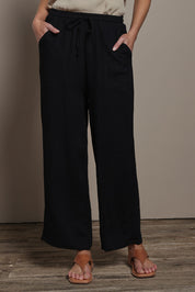 Model Madeline wearing size 10 of The Must Have Linen Look Pull on Pant in colour Black (Black), from the front, cropped image