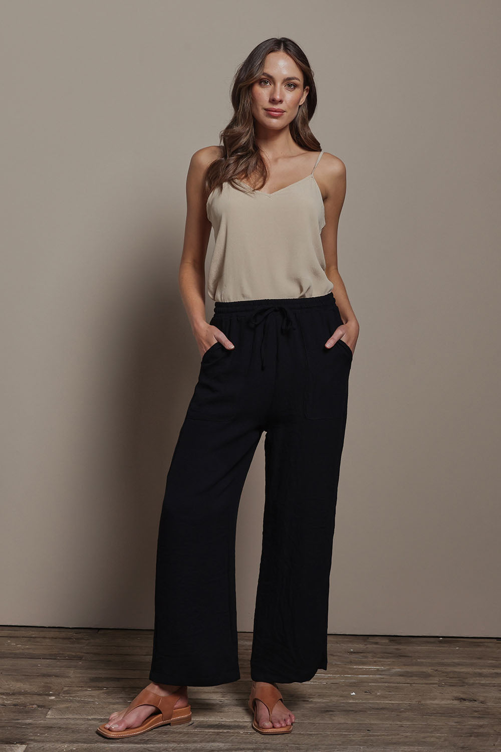 Model Madeline wearing size 10 of The Must Have Linen Look Pull on Pant in colour Black (Black), from the front, showing the whole outfit