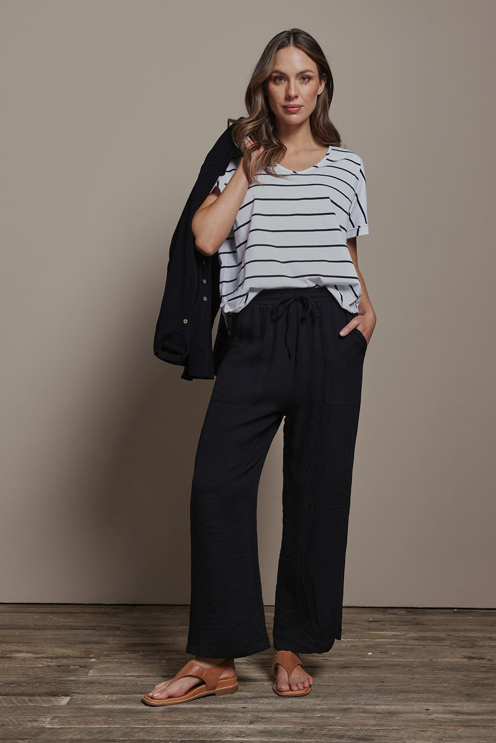 Model Madeline wearing size 10 of The Must Have Linen Look Pull on Pant in colour Black (Black), from the front, showing the whole outfit