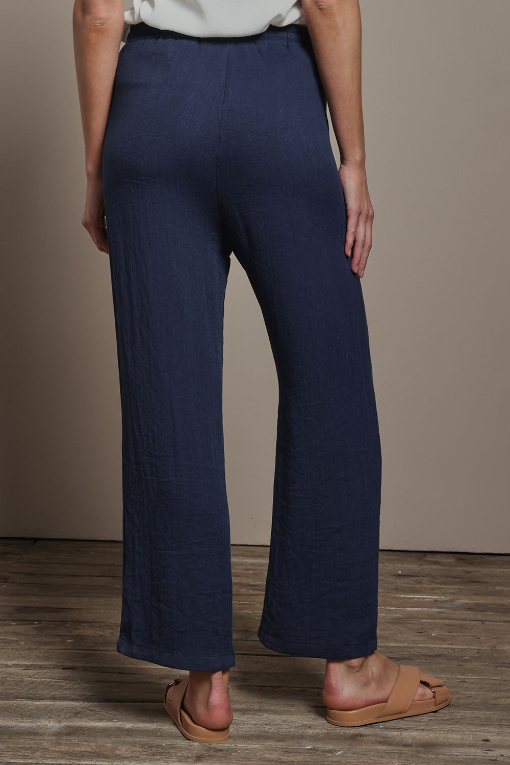 Model Madeline wearing size 10 of The Must Have Linen Look Pull on Pant in colour Darknavy (Blue), from the back