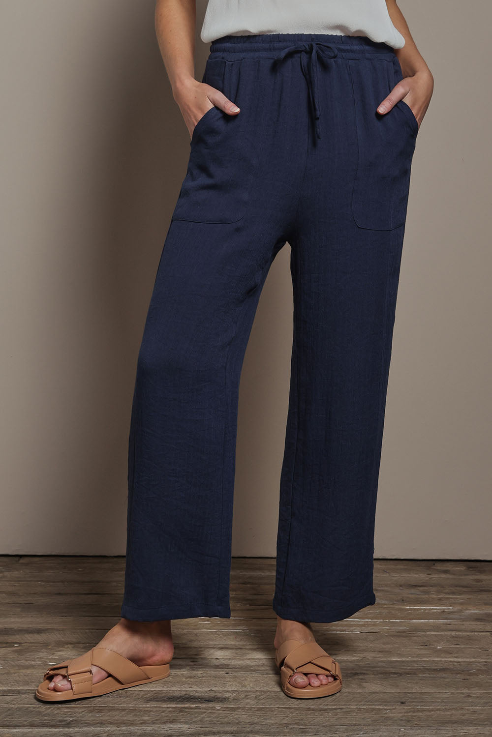 Model Madeline wearing size 10 of The Must Have Linen Look Pull on Pant in colour Darknavy (Blue), from the front, cropped image