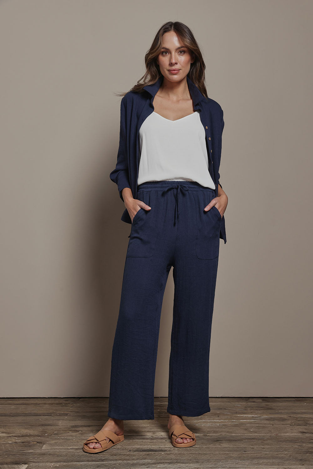 Model Madeline wearing size 10 of The Must Have Linen Look Pull on Pant in colour Darknavy (Blue), from the front, showing the whole outfit