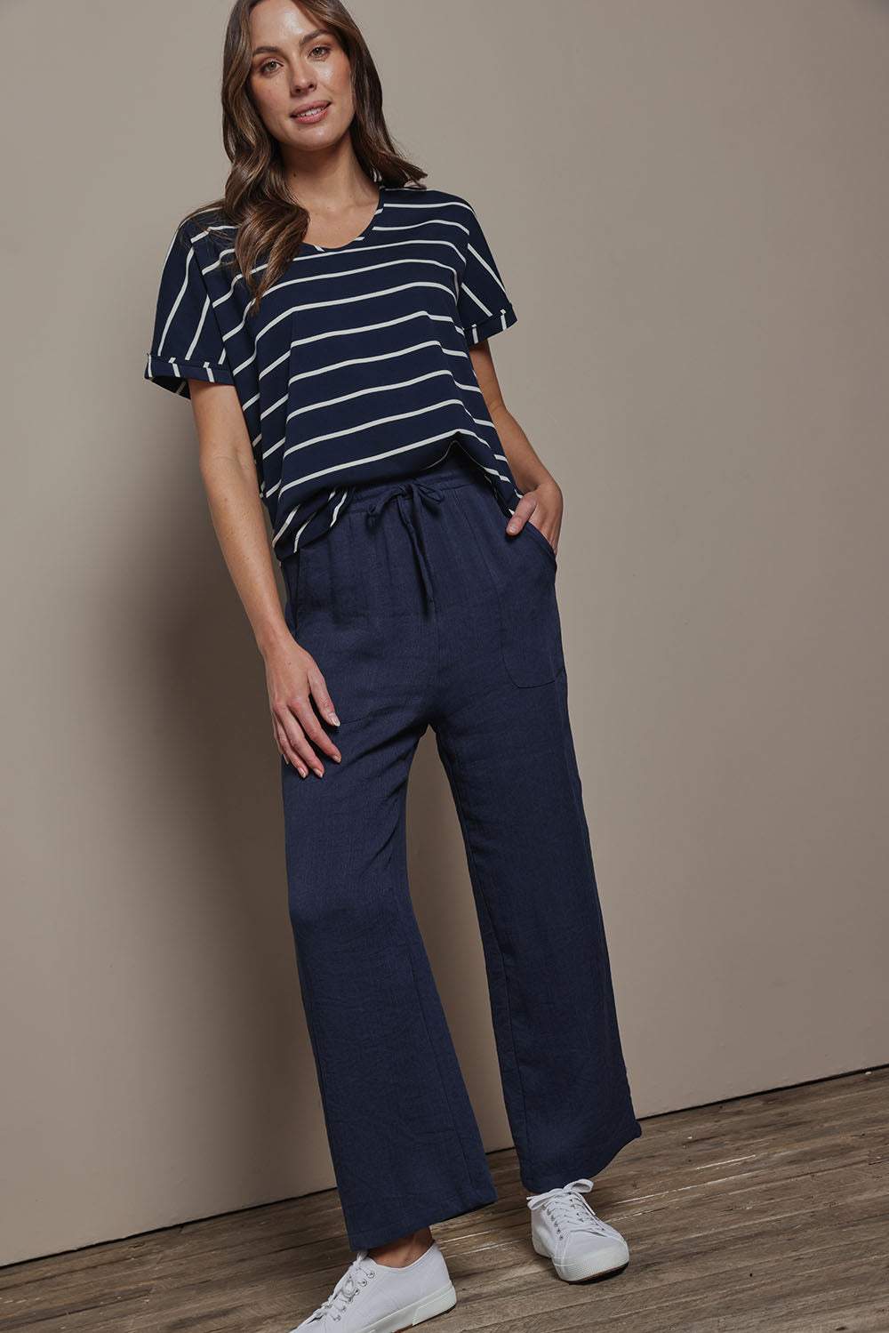 Model Madeline wearing size 10 of The Must Have Linen Look Pull on Pant in colour Darknavy (Blue), from the front, showing the whole outfit