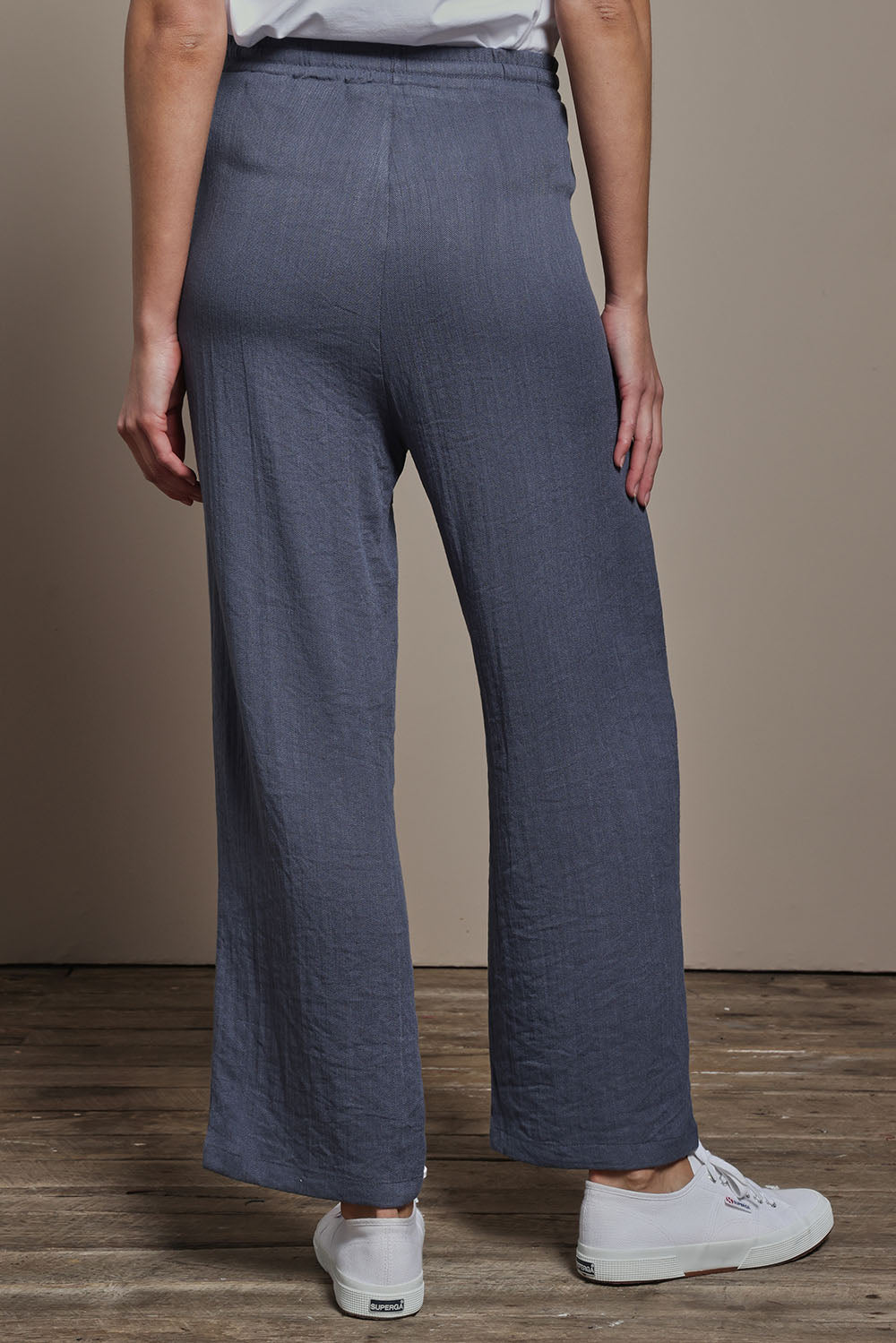 Model Madeline wearing size 10 of The Must Have Linen Look Pull on Pant in colour Denim (Blue), from the back