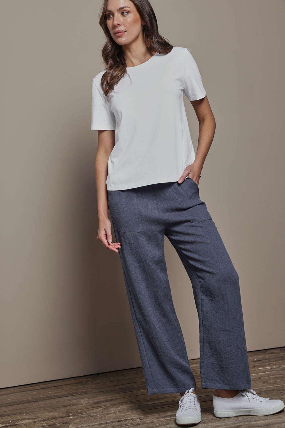 Model Madeline wearing size 10 of The Must Have Linen Look Pull on Pant in colour Denim (Blue), from the front, showing the whole outfit