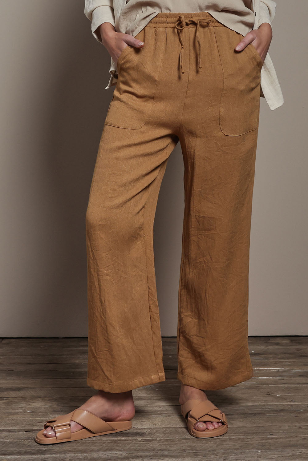 Model Madeline wearing size 10 of The Must Have Linen Look Pull on Pant in colour Latte, from the front, cropped image