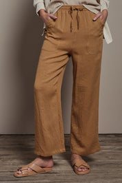 Model Madeline wearing size 10 of The Must Have Linen Look Pull on Pant in colour Latte, from the front, cropped image